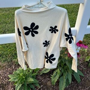 Long sleeve cream colored sweater with large black flowers
